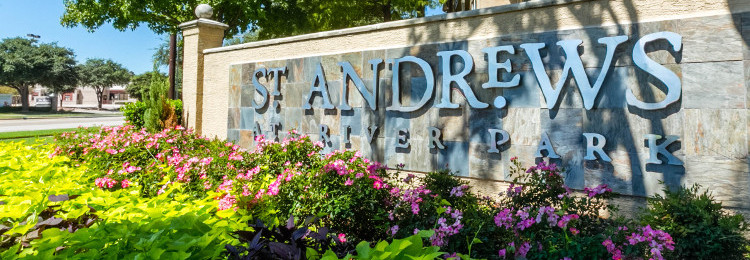 St. Andrews sign with bright flowers.