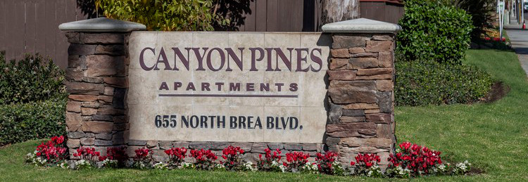 Property monument sign with lovely flowers.